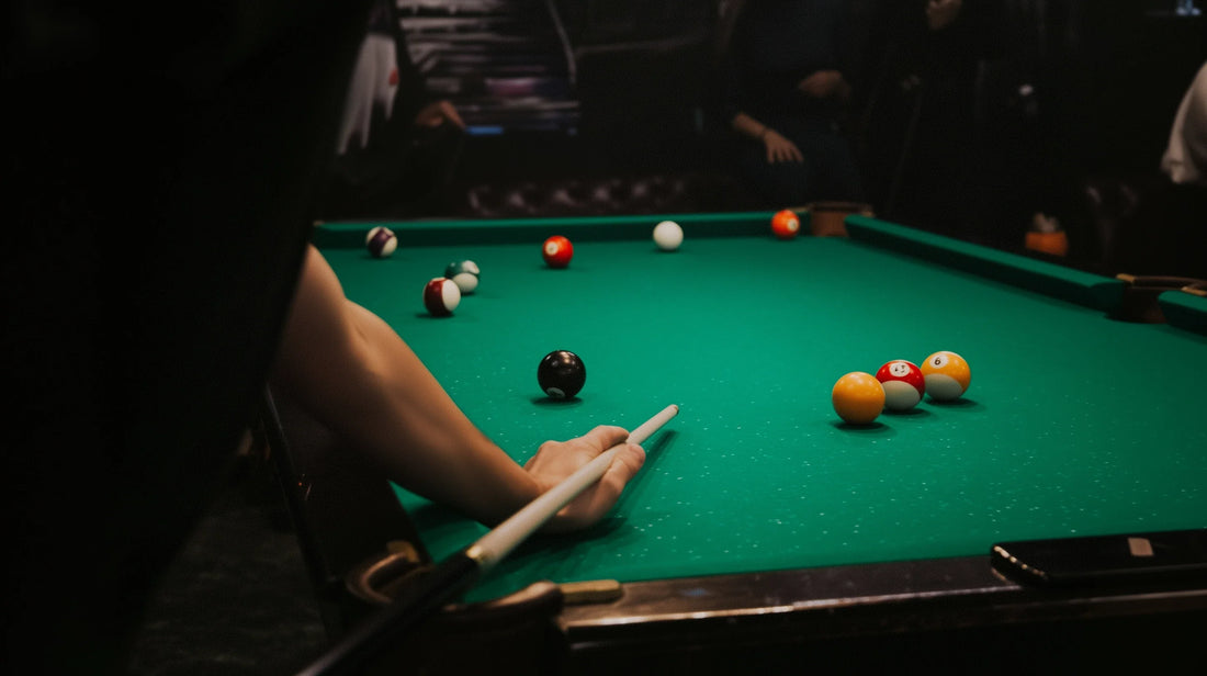 a pool player shooting at a green cloth table