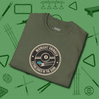 Midnight Grinder Badge T-Shirt, folded view, in Military Green because you don’t just play — you represent